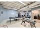 Finished basement with ping pong table, foosball, and home gym area; perfect for activities at 507 Falls Way, Woodstock, GA 30188