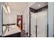 Spacious bathroom featuring double vanity, frameless shower, modern fixtures, and access to the bedroom at 507 Falls Way, Woodstock, GA 30188