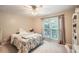 Cozy bedroom with a comfortable bed, bright window, neutral decor, and ample natural light at 507 Falls Way, Woodstock, GA 30188