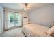 Inviting bedroom with natural light, plush carpeting, and a view of the outdoors at 507 Falls Way, Woodstock, GA 30188
