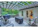 Outdoor deck area with pergola, covered grill, and seating for relaxing and entertaining at 507 Falls Way, Woodstock, GA 30188