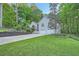 Inviting front exterior showcases a two-car garage, manicured lawn and mature trees at 507 Falls Way, Woodstock, GA 30188