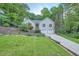 Charming home with a well-manicured lawn, a two-car garage, and mature landscaping at 507 Falls Way, Woodstock, GA 30188