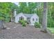 Back view of cozy house with landscaped yard, a serene setting, and a chimney at 507 Falls Way, Woodstock, GA 30188