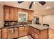 Kitchen with wood cabinetry, stone backsplash, granite counters and stainless steel appliances at 507 Falls Way, Woodstock, GA 30188