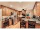 Open-concept kitchen featuring stainless steel appliances, wood cabinets, and a breakfast bar at 507 Falls Way, Woodstock, GA 30188