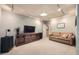 Comfortable carpeted living room with media center, recessed lighting, and neutral-toned sofa at 507 Falls Way, Woodstock, GA 30188