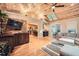 Spacious living room with hardwood floors, wood ceiling, skylights, and an open layout to the kitchen at 507 Falls Way, Woodstock, GA 30188