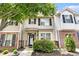 Charming townhome showcasing brick accents, neutral siding, black shutters, and a well-manicured front yard at 7244 Rockhouse Rd, Austell, GA 30168