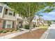 Attractive townhome showcasing a tree-lined street, brick accents, and well-maintained landscaping at 7244 Rockhouse Rd, Austell, GA 30168