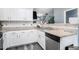 Well-lit kitchen with white cabinets, stainless steel appliances, and modern countertops at 7244 Rockhouse Rd, Austell, GA 30168
