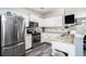 Modern kitchen featuring stainless steel appliances, granite countertops, and ample cabinet space at 7244 Rockhouse Rd, Austell, GA 30168