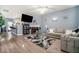 Open-concept living room features a fireplace, modern furniture, hardwood floors, and stylish accents at 7244 Rockhouse Rd, Austell, GA 30168