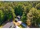 Aerial view of a wooded property featuring mature trees and an attractive home at 1027 Spring Mill Sw Dr, Lilburn, GA 30047