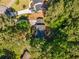 Aerial view of a wooded home with mature trees and a large driveway at 1027 Spring Mill Sw Dr, Lilburn, GA 30047