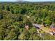 Panoramic aerial view of homes surrounded by mature trees in a lush, green landscape at 1027 Spring Mill Sw Dr, Lilburn, GA 30047