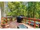Spacious wooden back deck featuring a grill and backyard views at 1027 Spring Mill Sw Dr, Lilburn, GA 30047