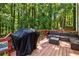 Outdoor back deck with grill and outdoor furniture at 1027 Spring Mill Sw Dr, Lilburn, GA 30047