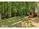 Grassy backyard with mature trees at 1027 Spring Mill Sw Dr, Lilburn, GA 30047