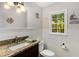 Cozy bathroom showcasing beadboard paneling, granite countertop, decorative accents, and natural light at 1027 Spring Mill Sw Dr, Lilburn, GA 30047