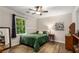 Sunlit bedroom features wood floors, a comfortable bed, and a view of the outdoors at 1027 Spring Mill Sw Dr, Lilburn, GA 30047