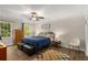 Bright bedroom with wood floors, a ceiling fan, natural light, and a comfortable bed setup at 1027 Spring Mill Sw Dr, Lilburn, GA 30047
