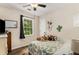 Bright bedroom featuring hardwood floors, natural light, and a ceiling fan at 1027 Spring Mill Sw Dr, Lilburn, GA 30047