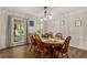 Elegant dining room featuring wood floors, a traditional table with seating, and ample natural light at 1027 Spring Mill Sw Dr, Lilburn, GA 30047