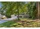 Charming two-story home featuring a well-kept lawn, an attached two-car garage, and mature trees at 1027 Spring Mill Sw Dr, Lilburn, GA 30047