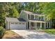 Lovely two-story home with an attached garage and a welcoming front porch enhanced by curb appeal at 1027 Spring Mill Sw Dr, Lilburn, GA 30047