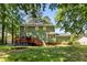 Exterior elevation of home with backyard and deck at 1027 Spring Mill Sw Dr, Lilburn, GA 30047