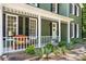 Cozy front porch with inviting bench seating, decorative plants, and charming curb appeal at 1027 Spring Mill Sw Dr, Lilburn, GA 30047