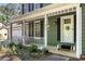Charming front porch with decorative wreath, hanging plants, and a welcome mat at the front door at 1027 Spring Mill Sw Dr, Lilburn, GA 30047