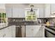 Updated kitchen with stainless steel appliances and stylish tile backsplash at 1027 Spring Mill Sw Dr, Lilburn, GA 30047