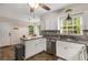 Spacious kitchen with white cabinets, stainless appliances and wood flooring at 1027 Spring Mill Sw Dr, Lilburn, GA 30047