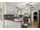 Modern kitchen with updated cabinets, granite countertops and stainless appliances at 1027 Spring Mill Sw Dr, Lilburn, GA 30047