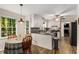 Open kitchen with gray countertops, stainless steel appliances, and eat-in breakfast area at 1027 Spring Mill Sw Dr, Lilburn, GA 30047