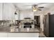 Kitchen featuring stainless steel appliances, stylish backsplash, and eat-in counter at 1027 Spring Mill Sw Dr, Lilburn, GA 30047