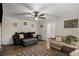 Well-lit living room features a ceiling fan, hardwood floors and neutral wall paint throughout at 1027 Spring Mill Sw Dr, Lilburn, GA 30047