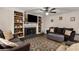 Bright living room with built-in shelves, a fireplace, hardwood floors, and a comfortable seating area at 1027 Spring Mill Sw Dr, Lilburn, GA 30047