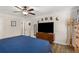 This main bedroom offers wood flooring, ceiling fan, and a decorative accent wall at 1027 Spring Mill Sw Dr, Lilburn, GA 30047