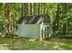 A nice looking shed on a well kept lawn with mature trees nearby at 1027 Spring Mill Sw Dr, Lilburn, GA 30047