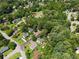 An aerial view shows the home nestled among lush green trees in a tranquil neighborhood at 1275 Muirforest Way, Stone Mountain, GA 30088