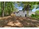 A large private backyard with a deck offers serene outdoor living space surrounded by mature trees for added privacy at 1275 Muirforest Way, Stone Mountain, GA 30088
