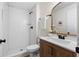 Bathroom features wood vanity, white subway tile shower, gold trimmed mirror and black hardware at 1275 Muirforest Way, Stone Mountain, GA 30088