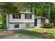 Charming renovated home with a modern color scheme and inviting curb appeal surrounded by mature trees at 1275 Muirforest Way, Stone Mountain, GA 30088