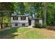 Charming renovated two-story home featuring a black door, black framed windows, and refreshed landscaping at 1275 Muirforest Way, Stone Mountain, GA 30088