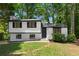 Charming two-story home boasts a freshly painted exterior, enhancing its curb appeal, and inviting front yard at 1275 Muirforest Way, Stone Mountain, GA 30088