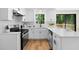 Well-appointed kitchen featuring white cabinets, sleek countertops, and modern appliances at 1275 Muirforest Way, Stone Mountain, GA 30088