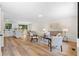 Bright, open-concept living area features hardwood floors that connect the living, dining, and kitchen spaces at 1275 Muirforest Way, Stone Mountain, GA 30088